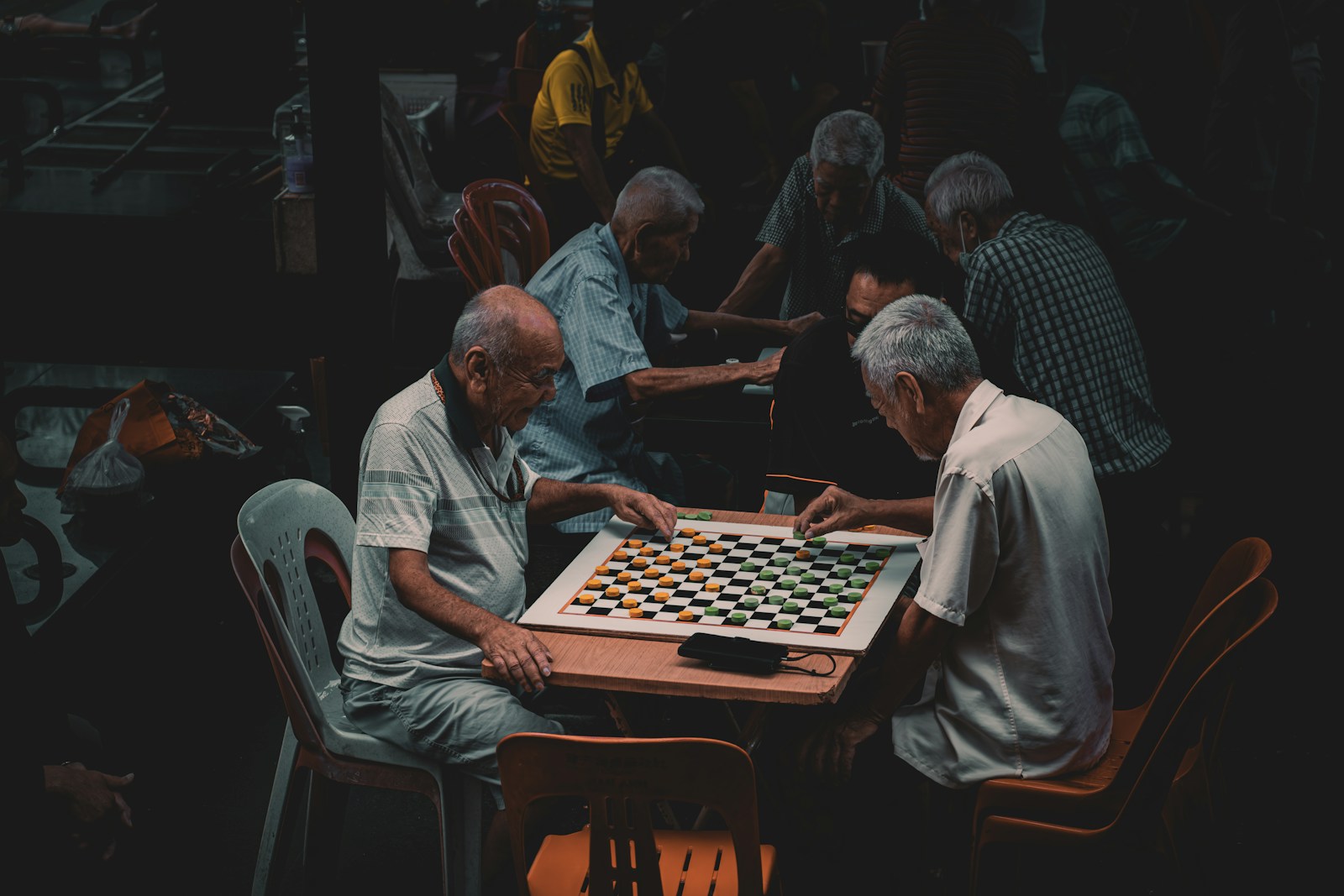 a group of older men playing a game of chess
