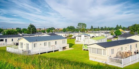 Static caravan holiday park with rows of lodges and green lawns